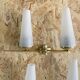 Pair of vintage double wall lights in brass with white ribbed glass tulips.