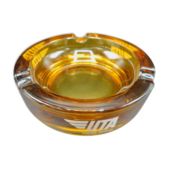 Round ashtray in amber glass