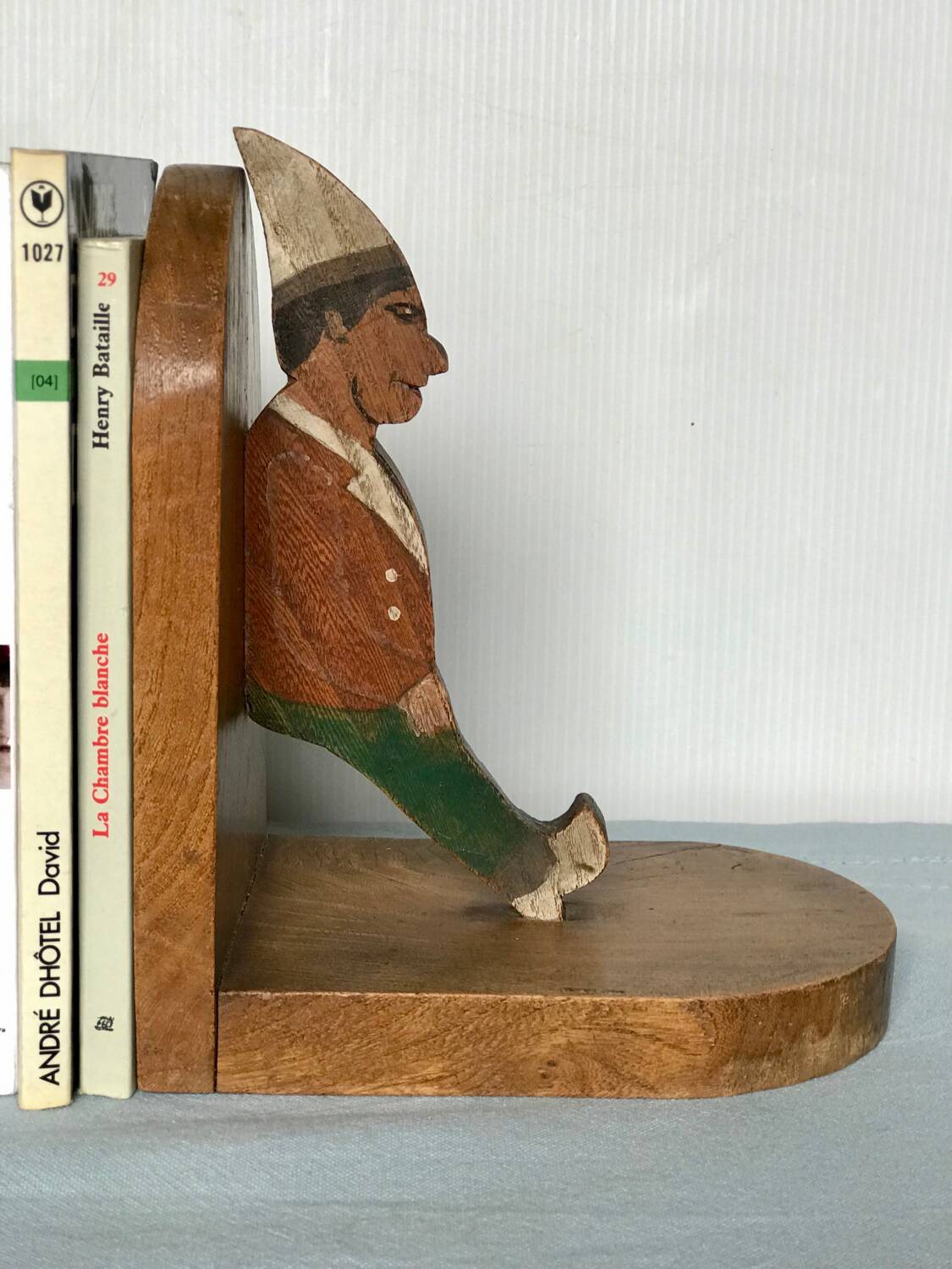 Old wooden bookends with painted characters