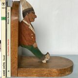 Old wooden bookends with painted characters