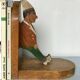 Old wooden bookends with painted characters