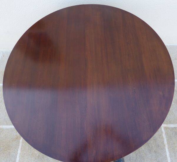 Round mahogany table with mahogany veneer and brass sabot foot.