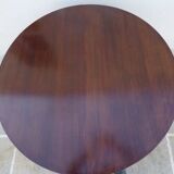 Round mahogany table with mahogany veneer and brass sabot foot.