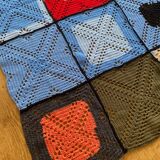Hand-knitted patchwork blanket