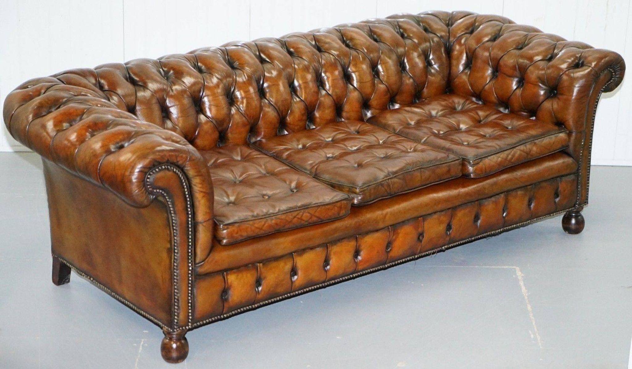 Restored vintage leather Chesterfield canapé in Thomas Chippendale style.