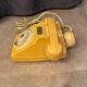 Old dial telephone from the 80s temat quimper bakelite yellow and beige