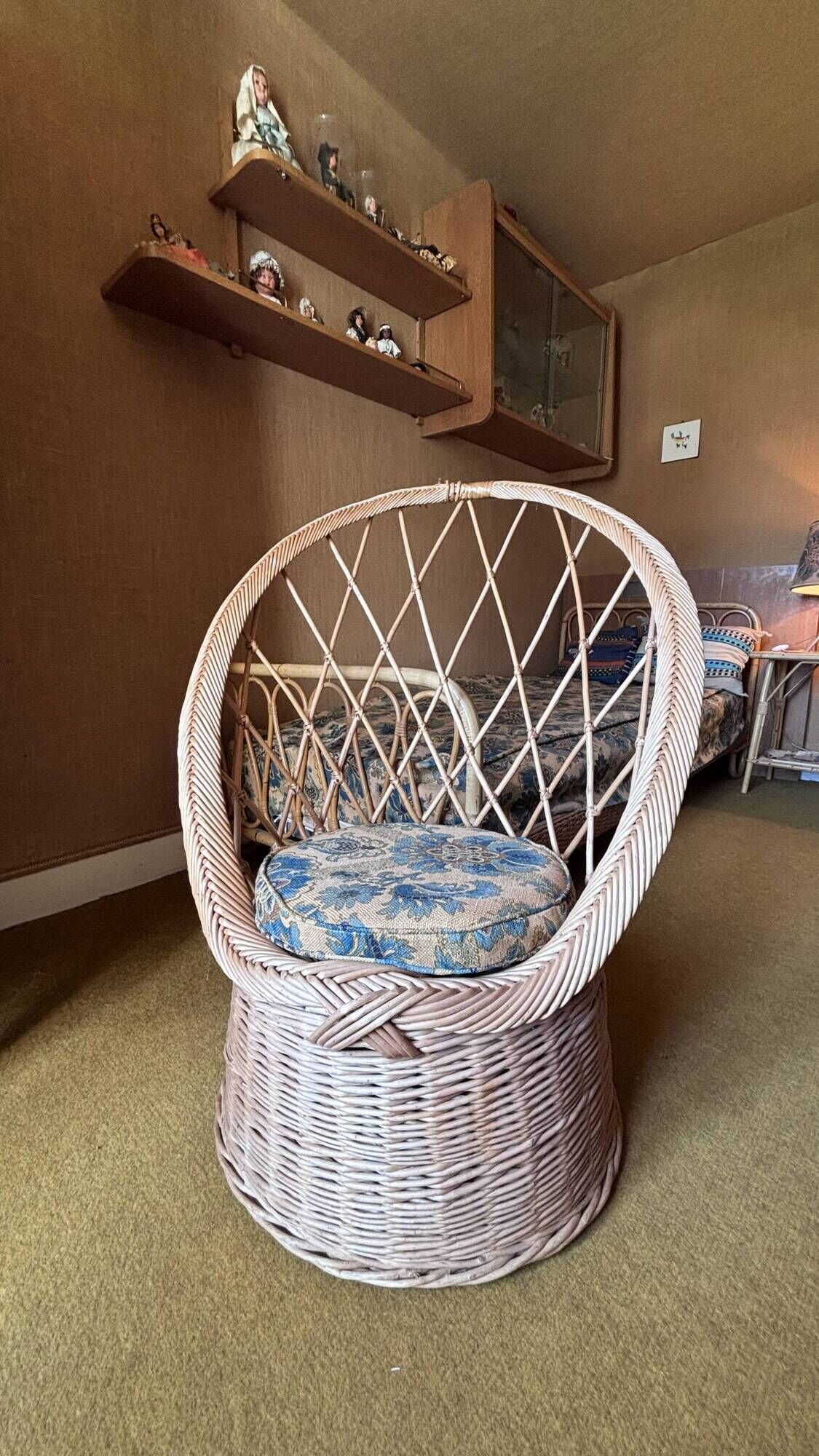Vintage shell chair in woven rattan with original cushion.