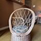 Vintage shell chair in woven rattan with original cushion.