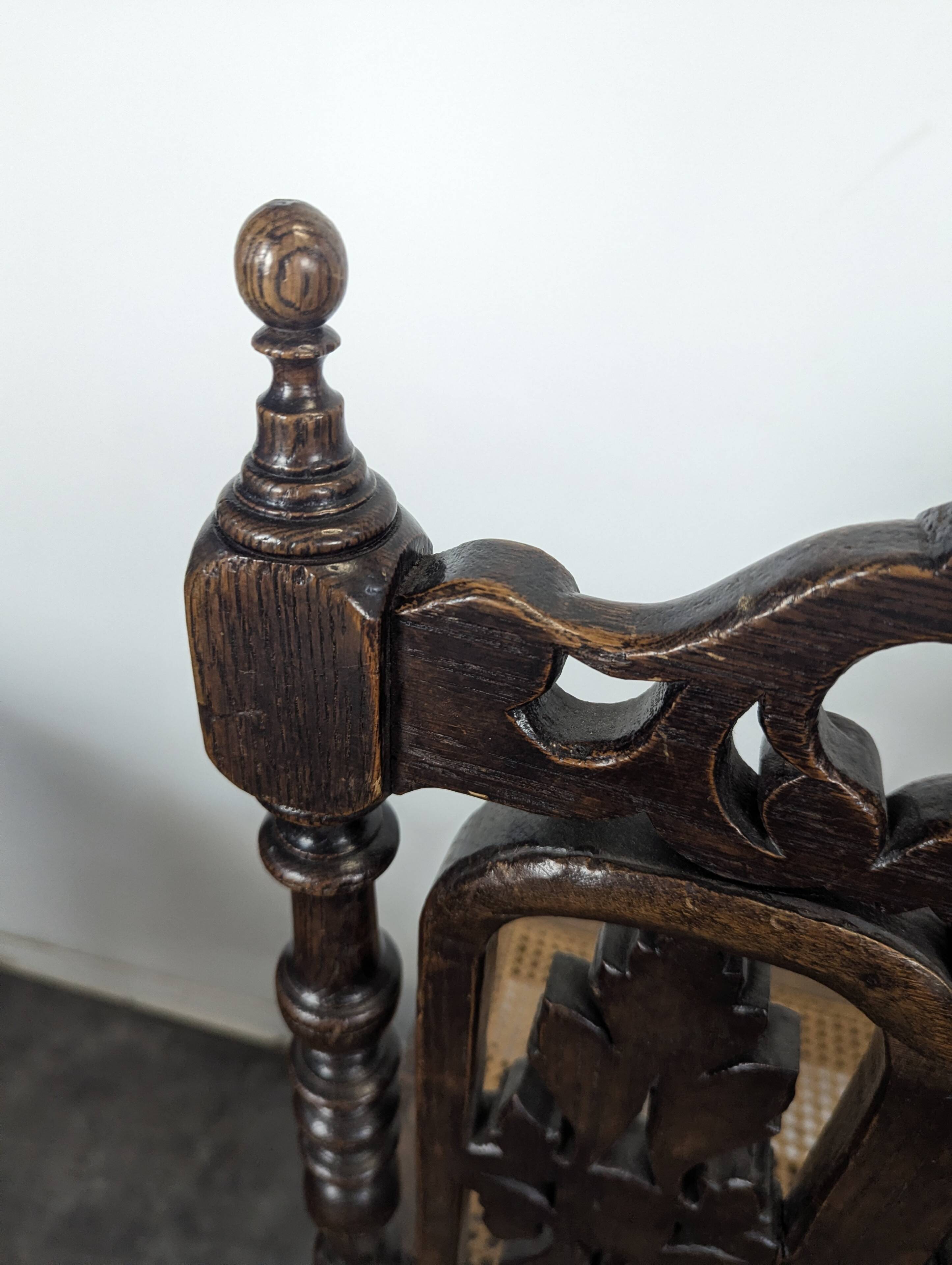 Set of 6 Henri II chairs in carved openwork oak with caned seats.