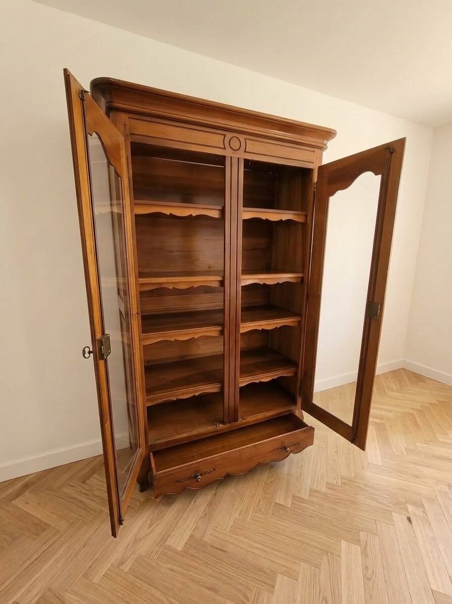 Louis XV style library in cherry wood with glass doors.