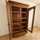 Louis XV style library in cherry wood with glass doors.