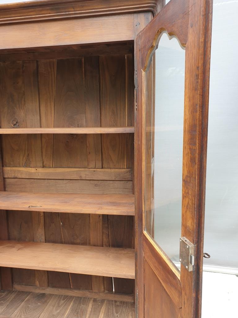 Walnut glazed bookcase with nineteenth century rose window