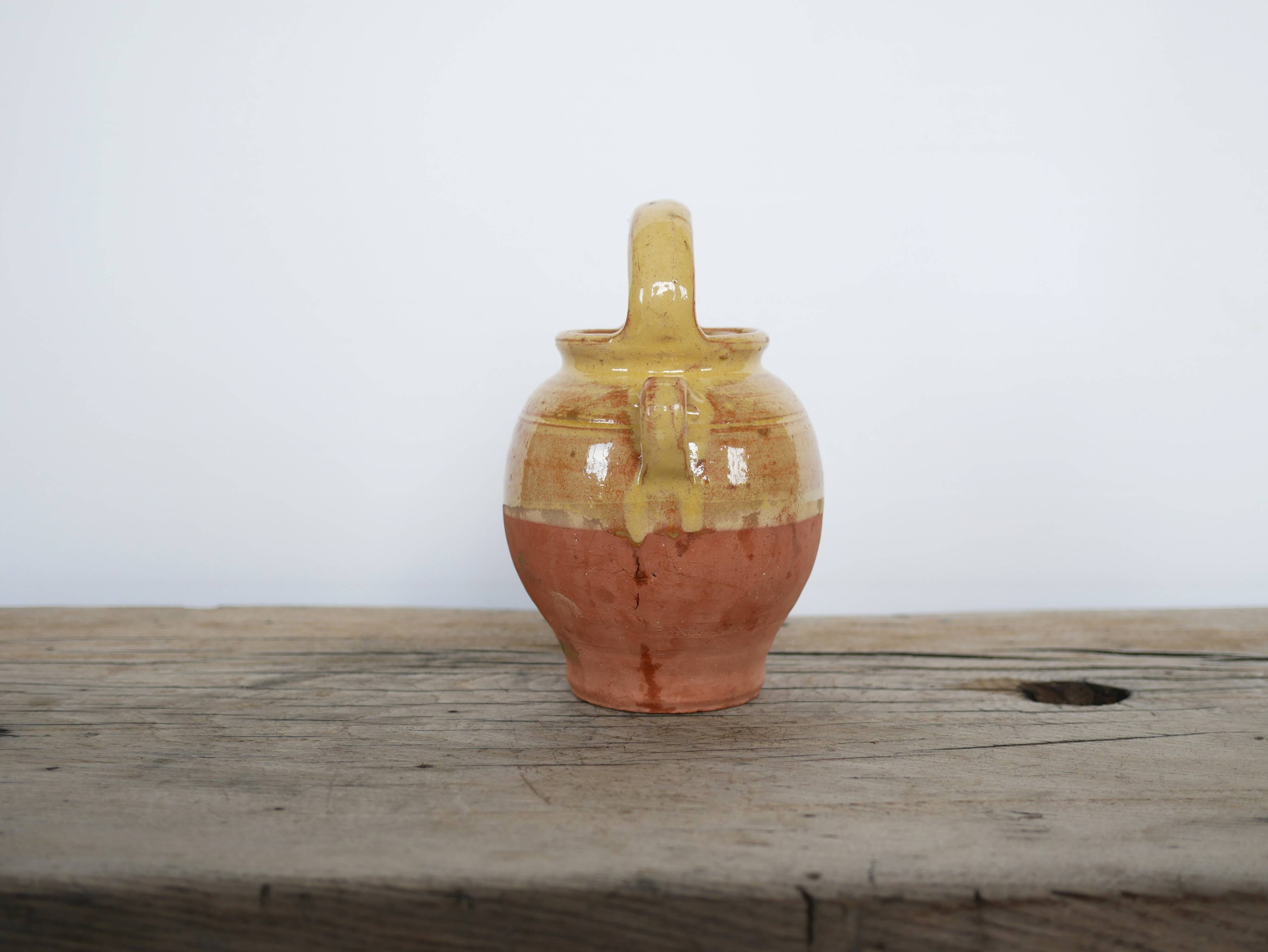 Old gargoulette pot in glazed terracotta