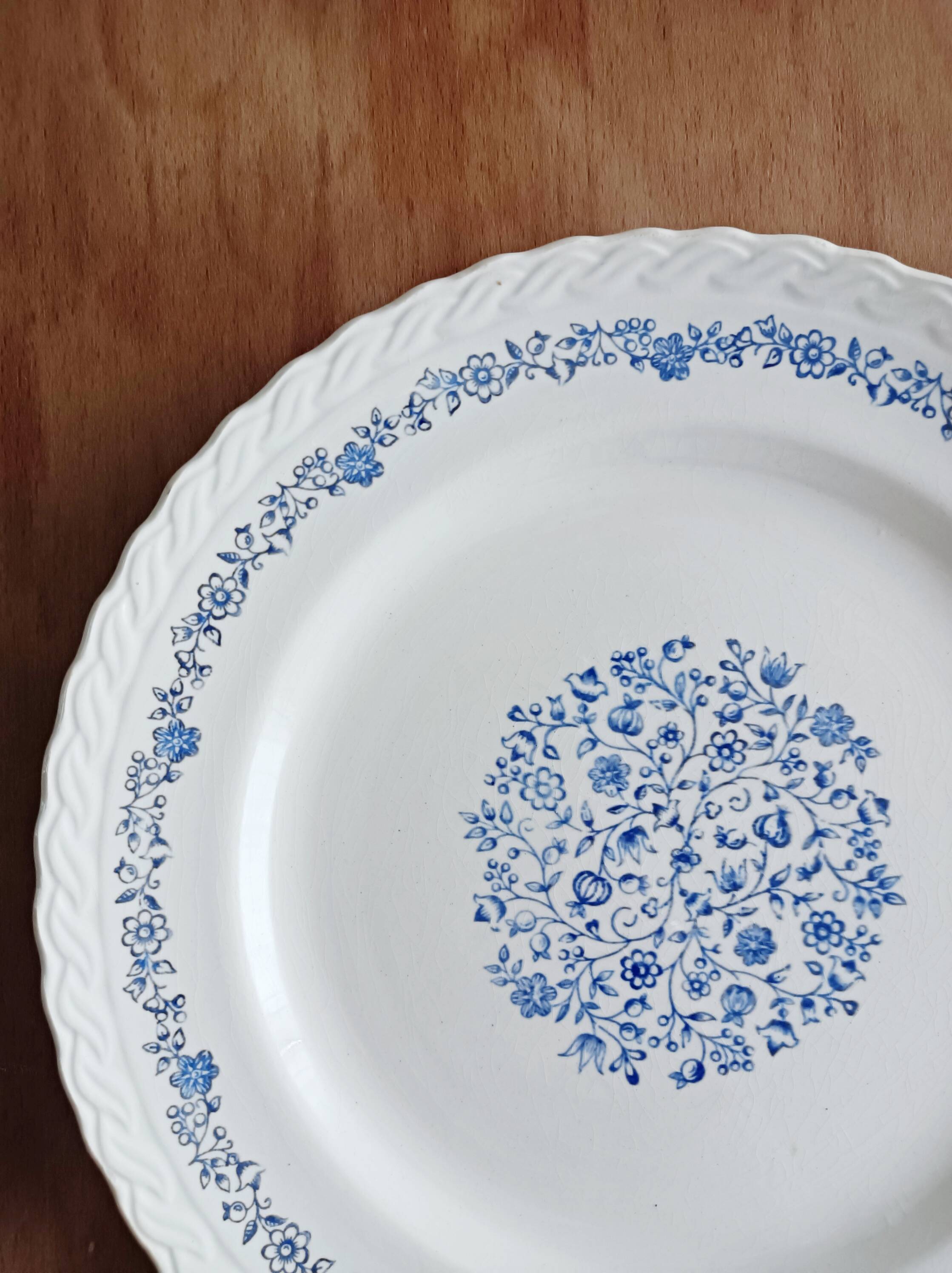 Round antique earthenware dish with floral decoration