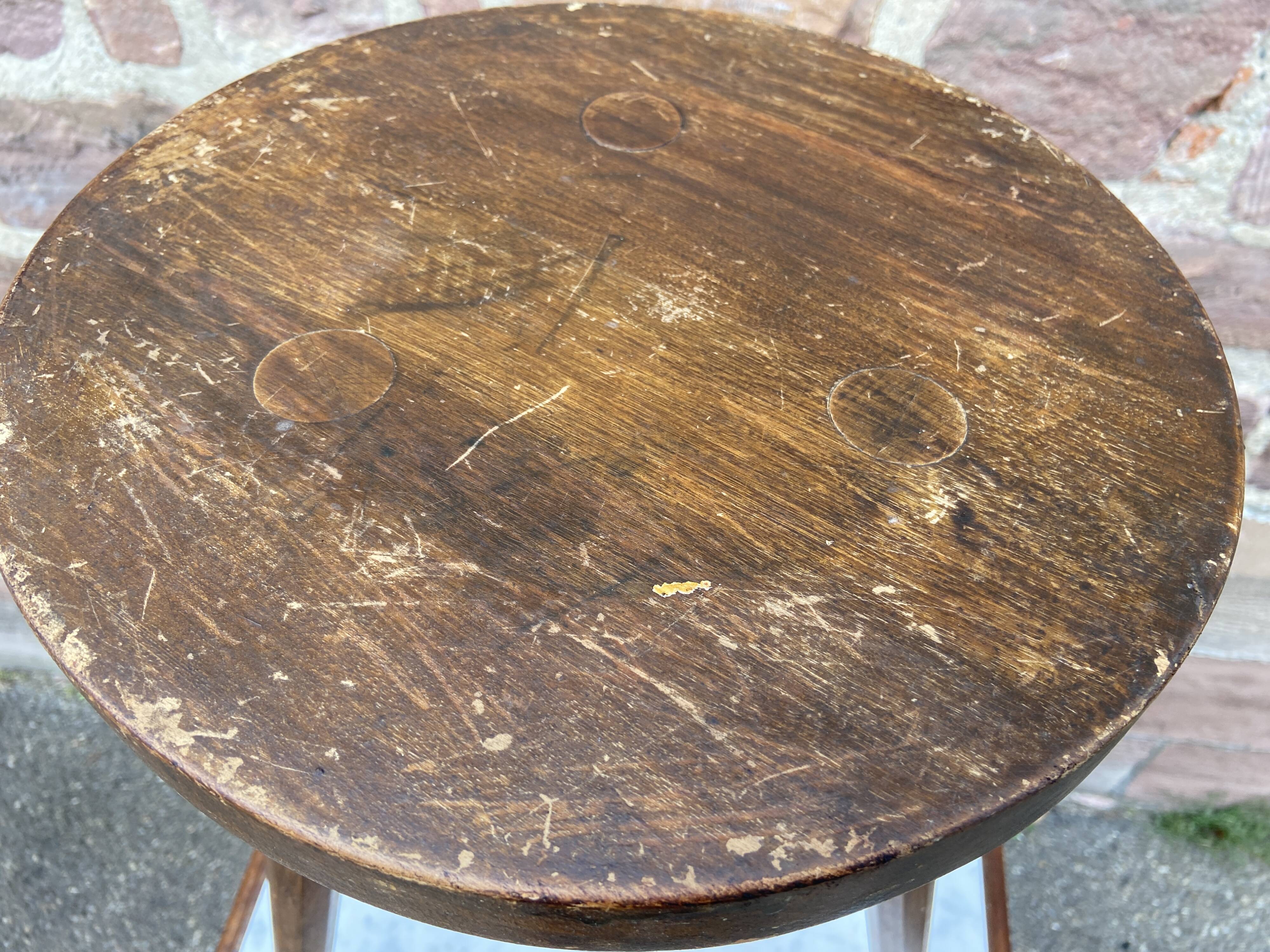 Brutalist rustic tripod farm stool made of vintage wood