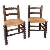 Pair of vintage armchairs with turned wood and woven rope seat.