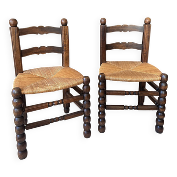 Paire de fauteuils vintage en bois tourné et assise en corde tressée