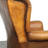 Sheepskin wingback chair with a unique design and a beautiful patina