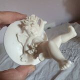Small round box topped with a vintage biscuit porcelain angel