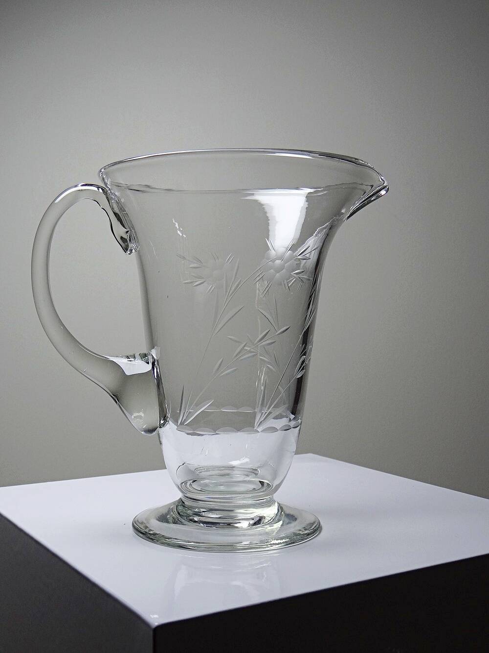 Antique glass pitcher with wheel engraving and floral decoration, Bohemia, early 20th century.