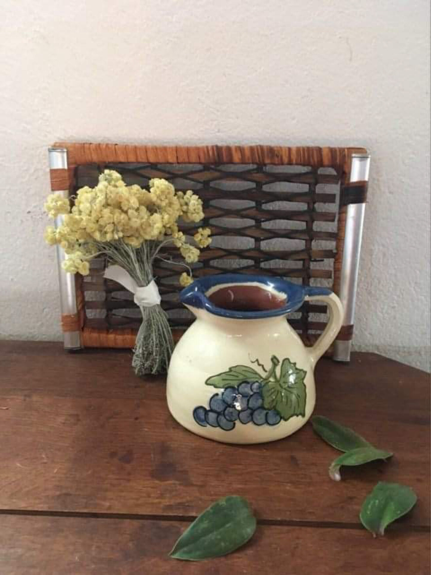 Terracotta jug with grape decoration.