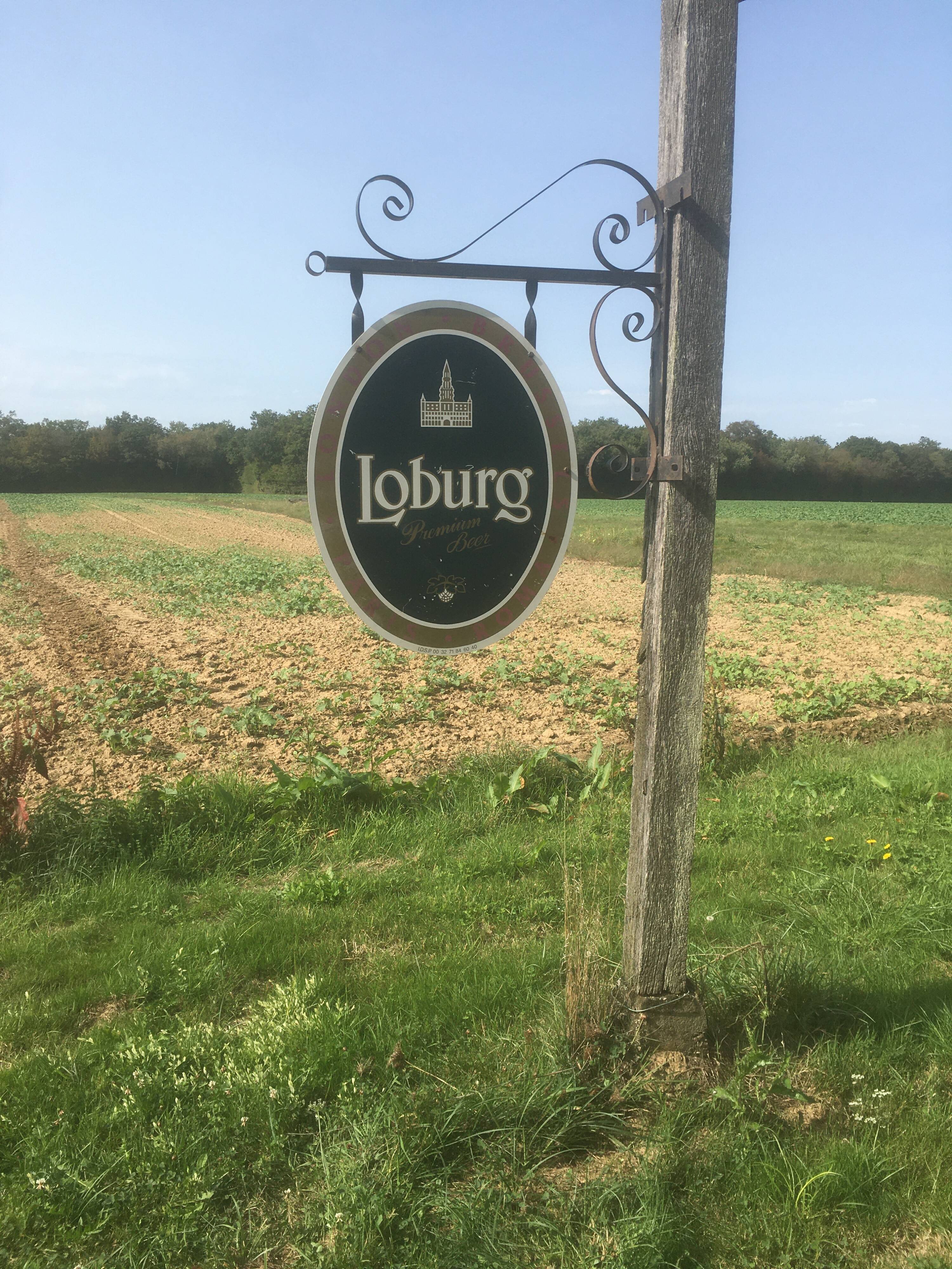 Double-sided "Loburg Beer" metal sign on wrought iron bracket