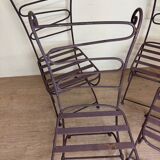 Series of four designer cast iron chairs with reversed backs and very beautiful x-legs