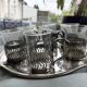 6 small glasses in their silver metal holder, with handle