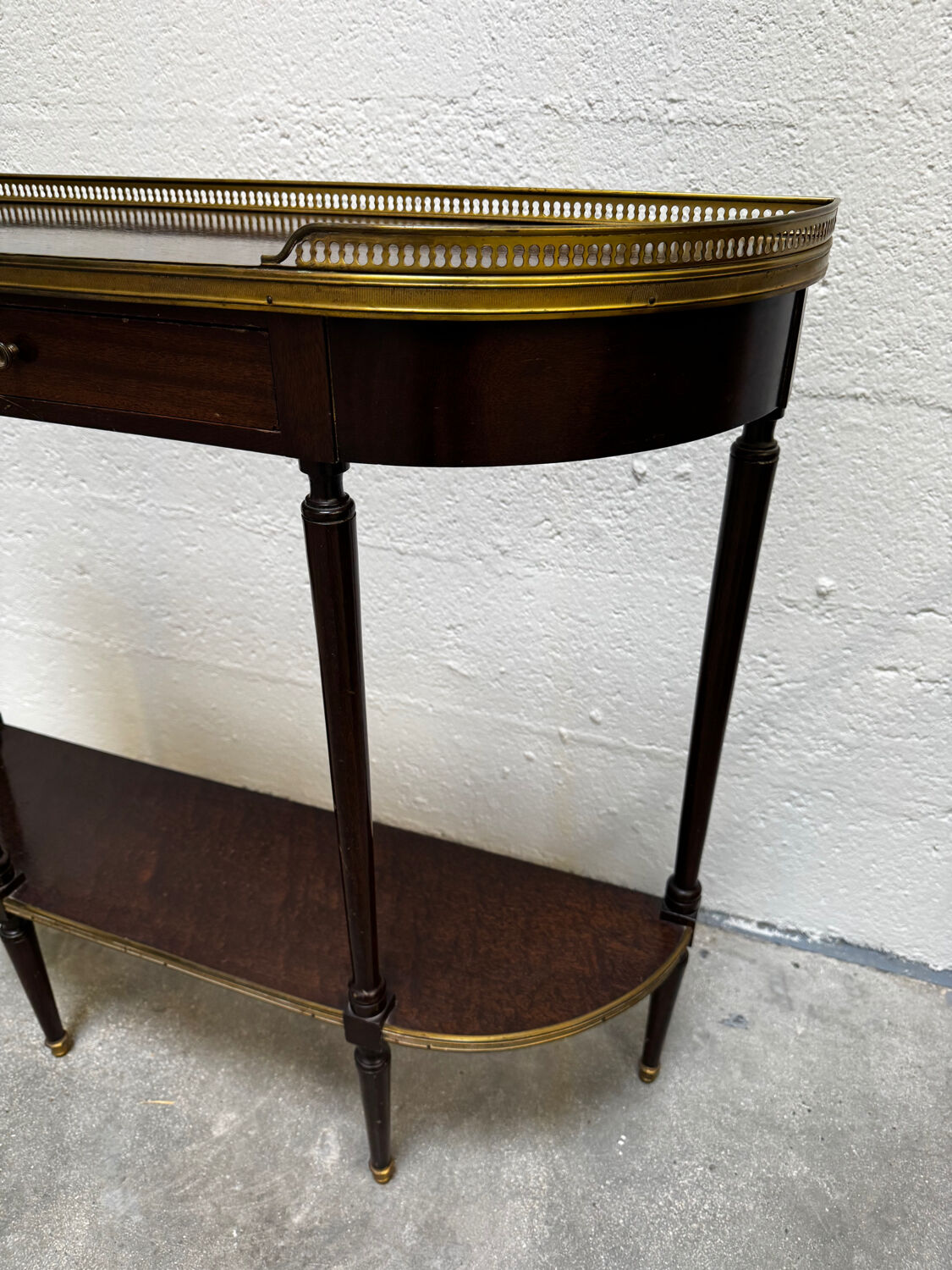 Louis XVI demi-moon console in wood and brass.