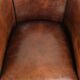 Sheepskin club armchair with deep warm colours and black piping