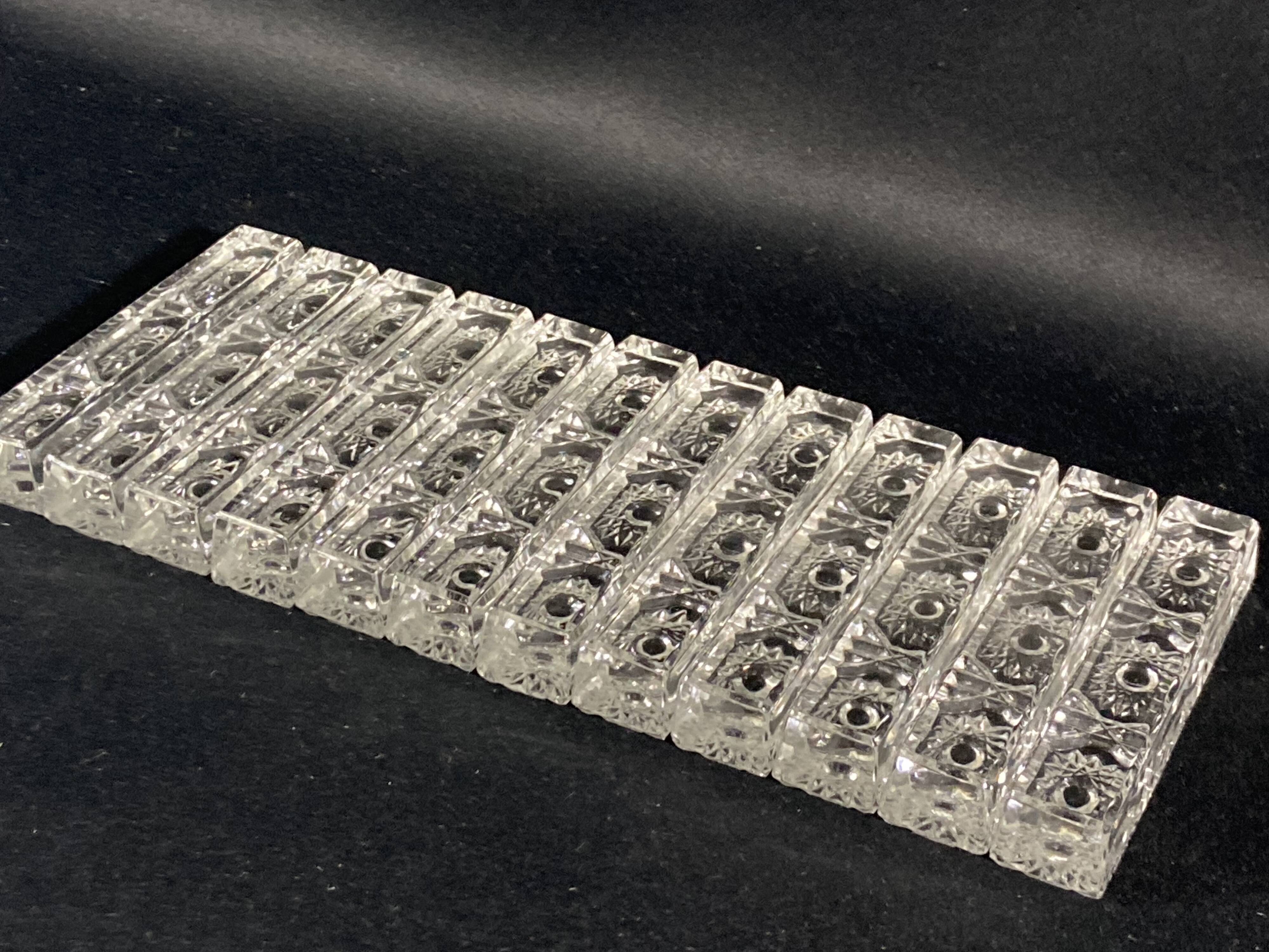 Set of 12 molded glass or crystal knife rests with diamond point decor