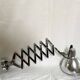 Vintage accordion wall light in chrome metal.