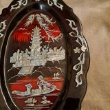 Marquetes lacquer dish with mother-of-pearl inlays figuring 3 characters on a boat in front of a temple.