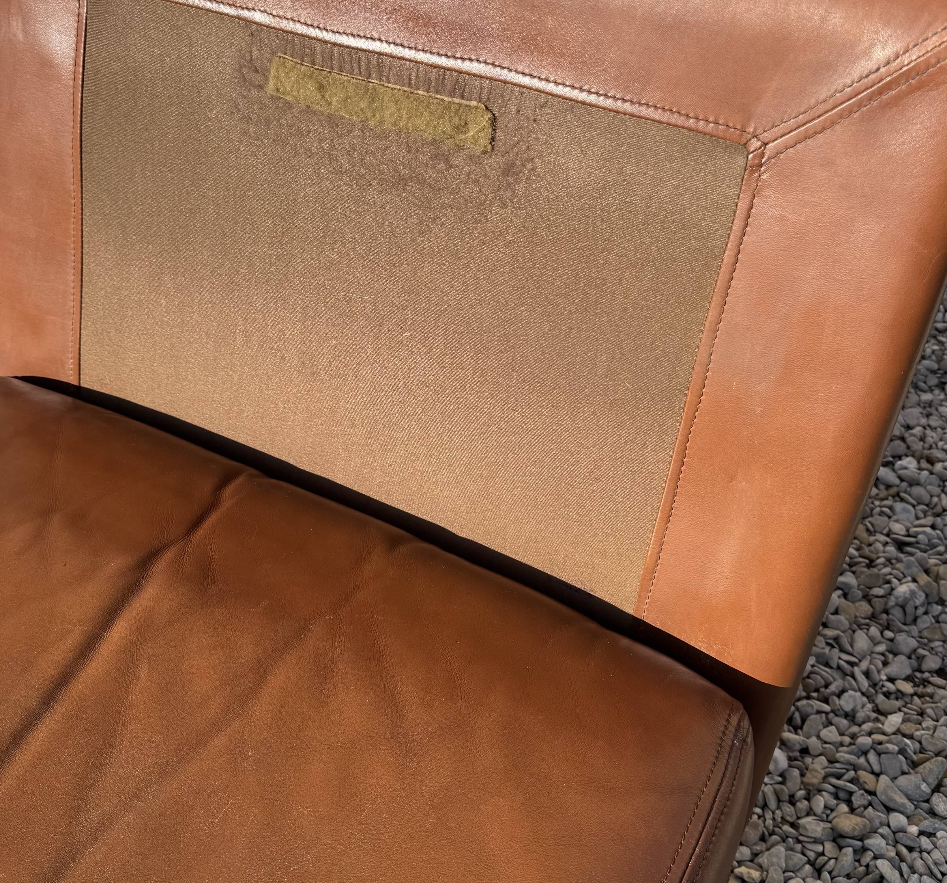 2 armchairs and 1 ottoman in brushed aluminium and brown leather, France, 1970.