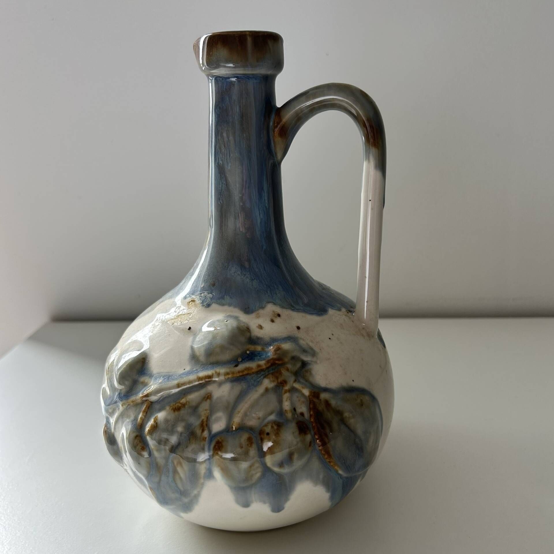 Cherry-decorated earthenware carafe