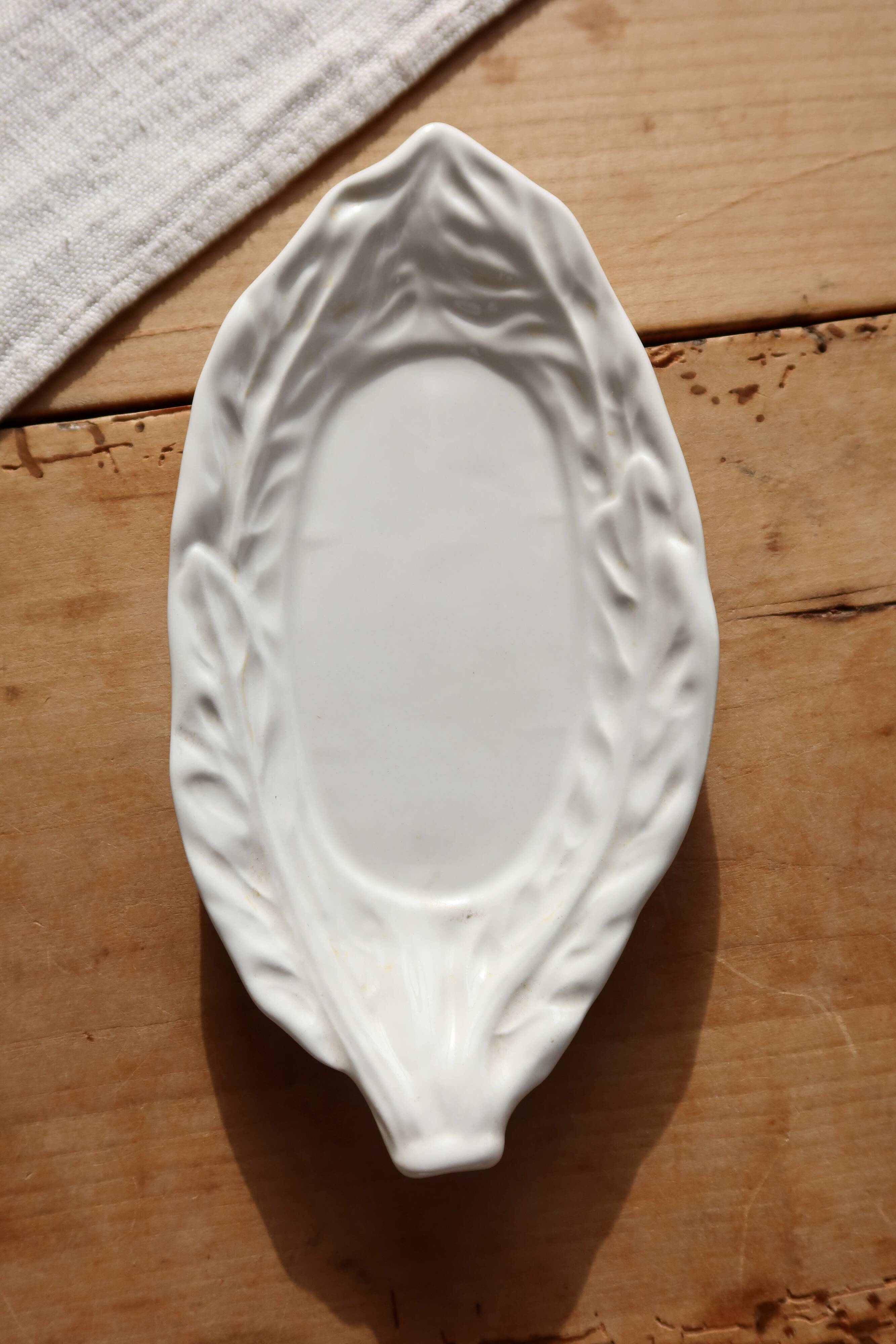 Antique leaf-shaped white English slipware dish.