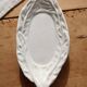 Antique leaf-shaped white English slipware dish.