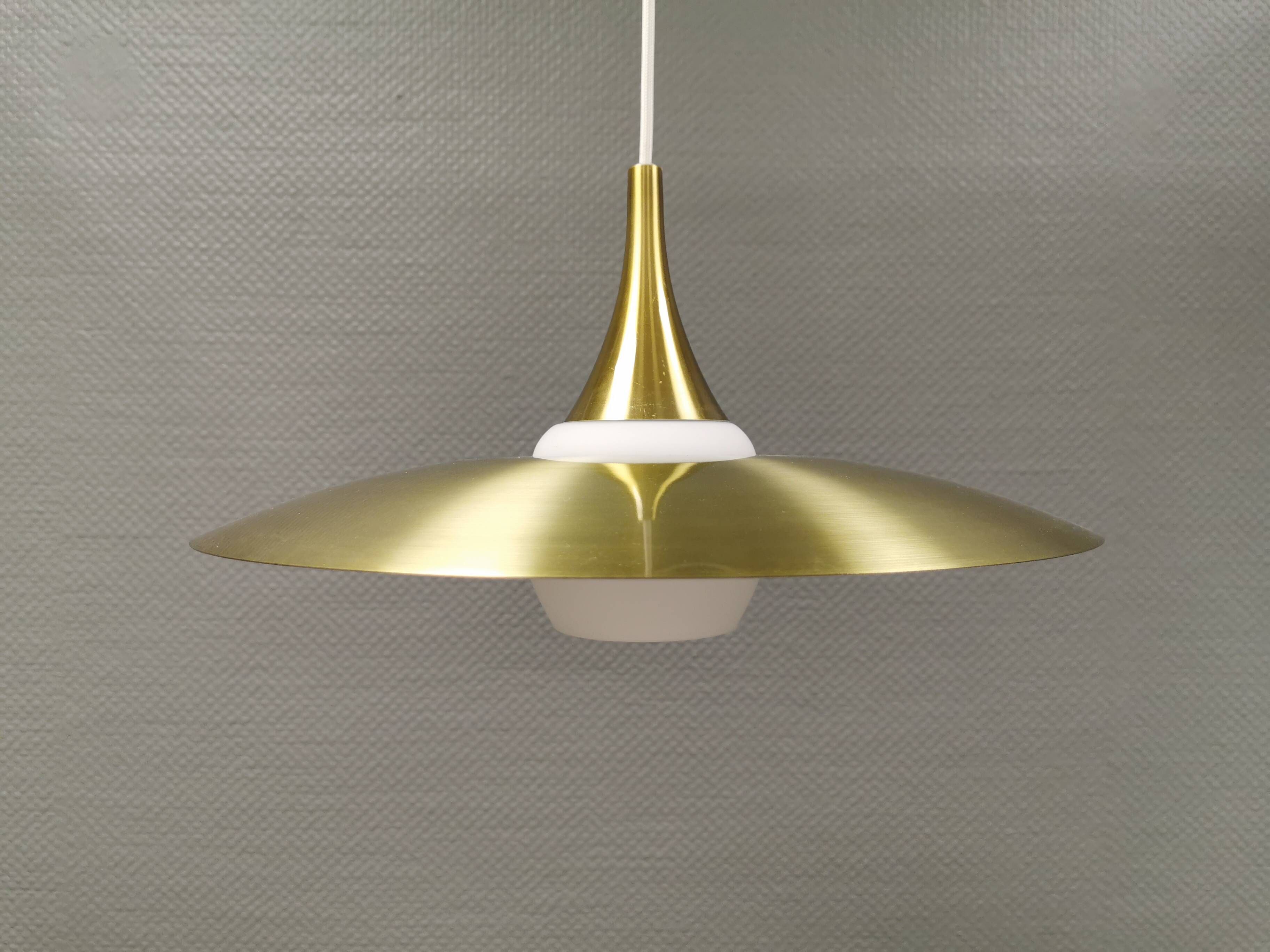 Hanging lamp, from the 1970s in matte white glass and brass colored metal.