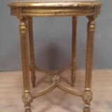 Oval coffee table in gilded wood in the Louis XVI style.