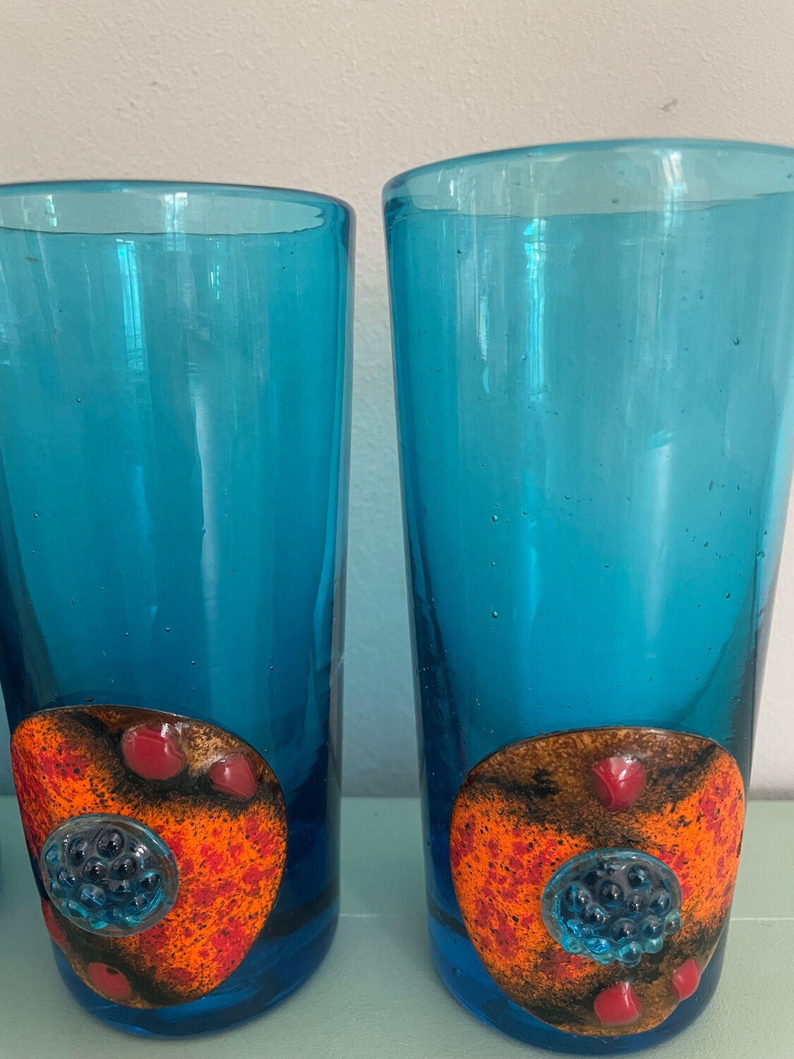 Six blue blown glass and enamel on copper glasses.