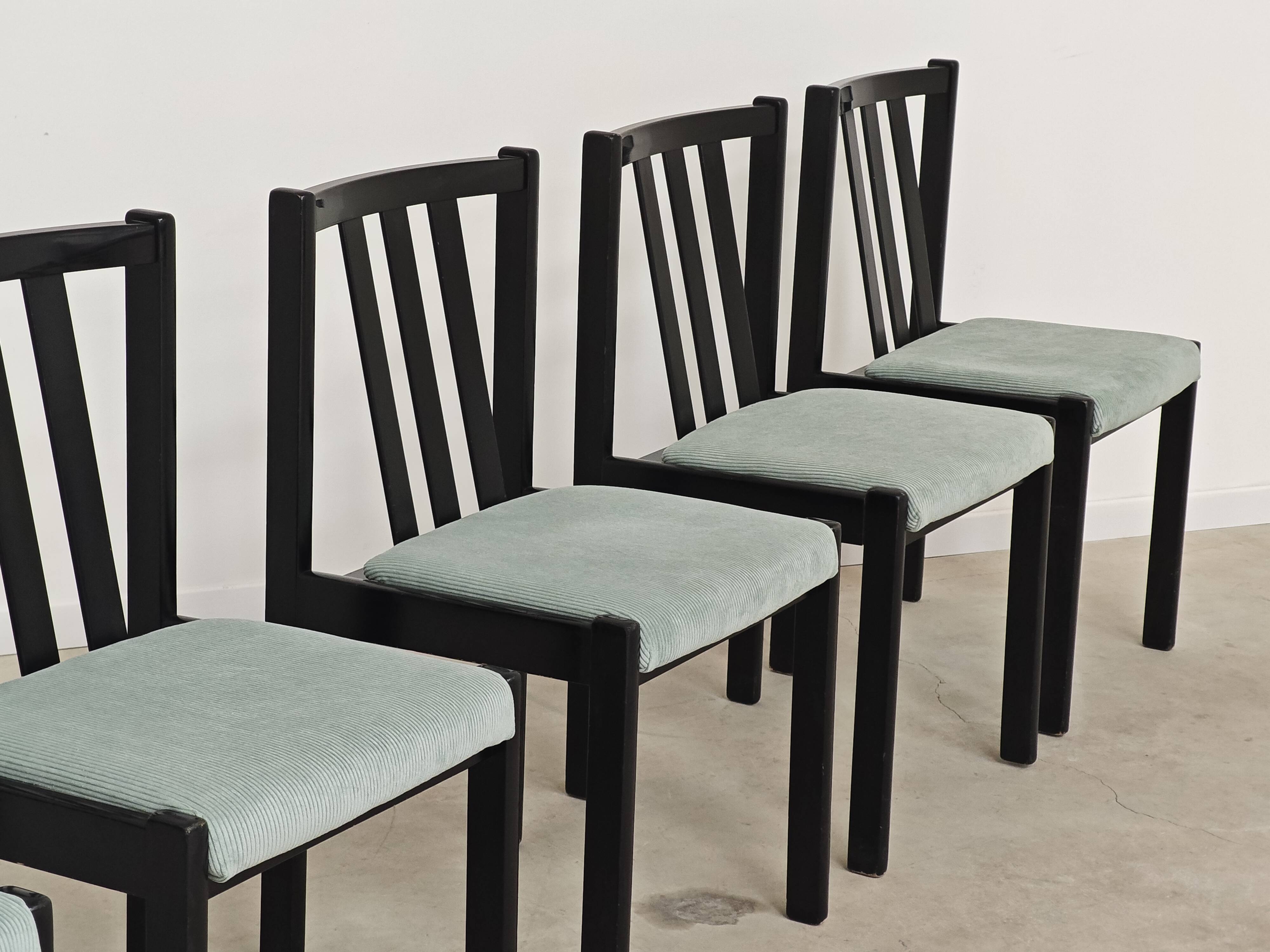 Set of 6 modernist black chairs with light blue-green ribbed fabric.