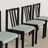 Set of 6 modernist black chairs with light blue-green ribbed fabric.