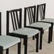 Set of 6 modernist black chairs with light blue-green ribbed fabric.