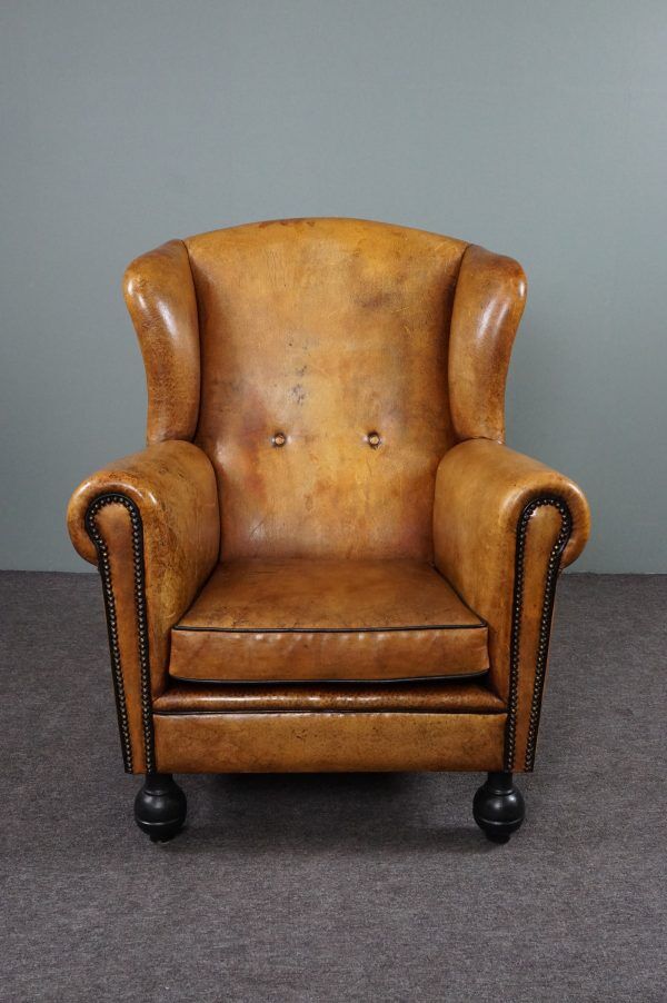 Antique armchair in patinated sheepskin