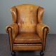 Antique armchair in patinated sheepskin