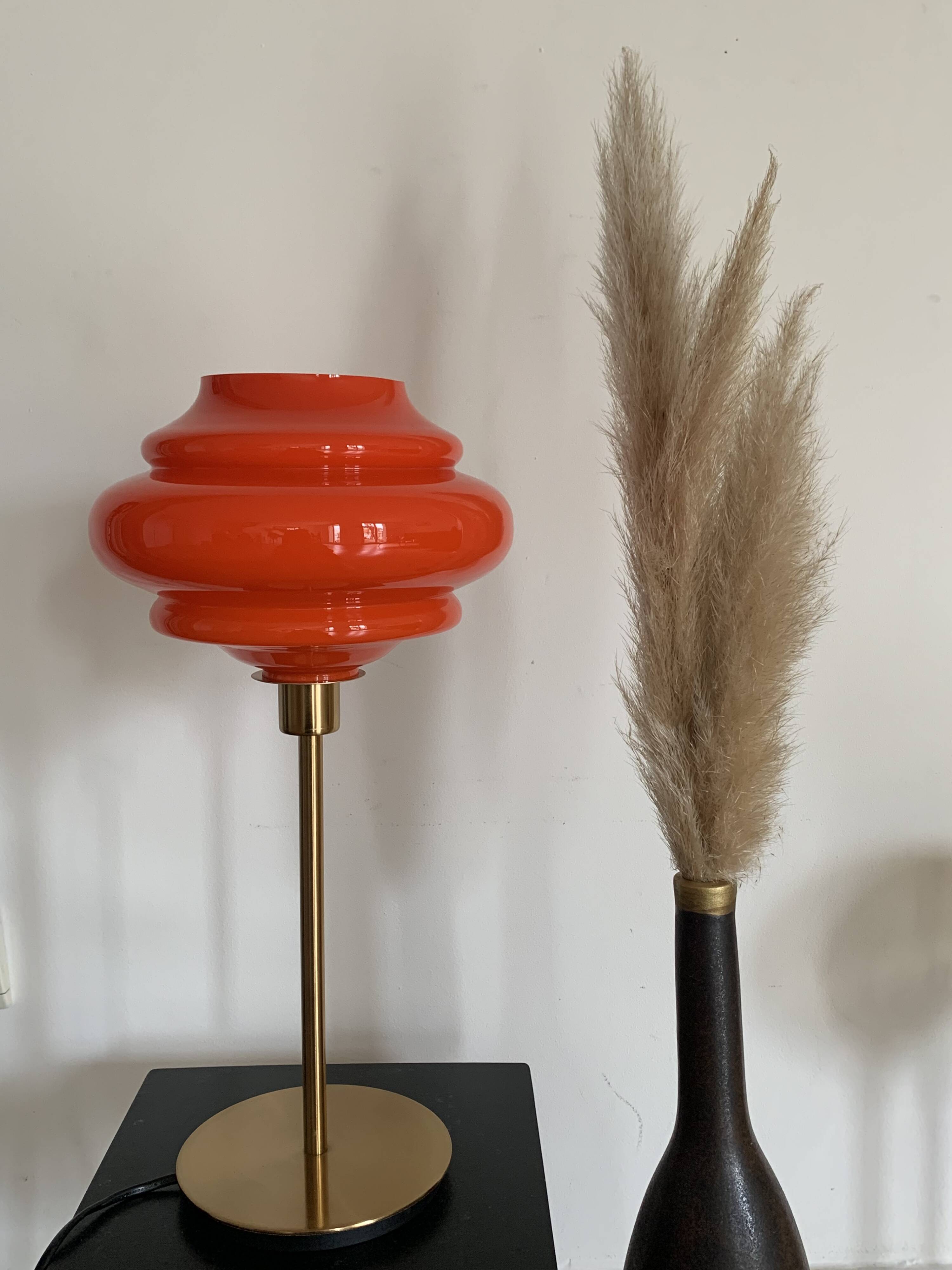 Table lamp with a vintage orange globe from an old pendant light
