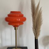 Table lamp with a vintage orange globe from an old pendant light