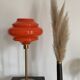 Table lamp with a vintage orange globe from an old pendant light