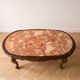 Table basse ovale en marbre et bois sculpté style baroque