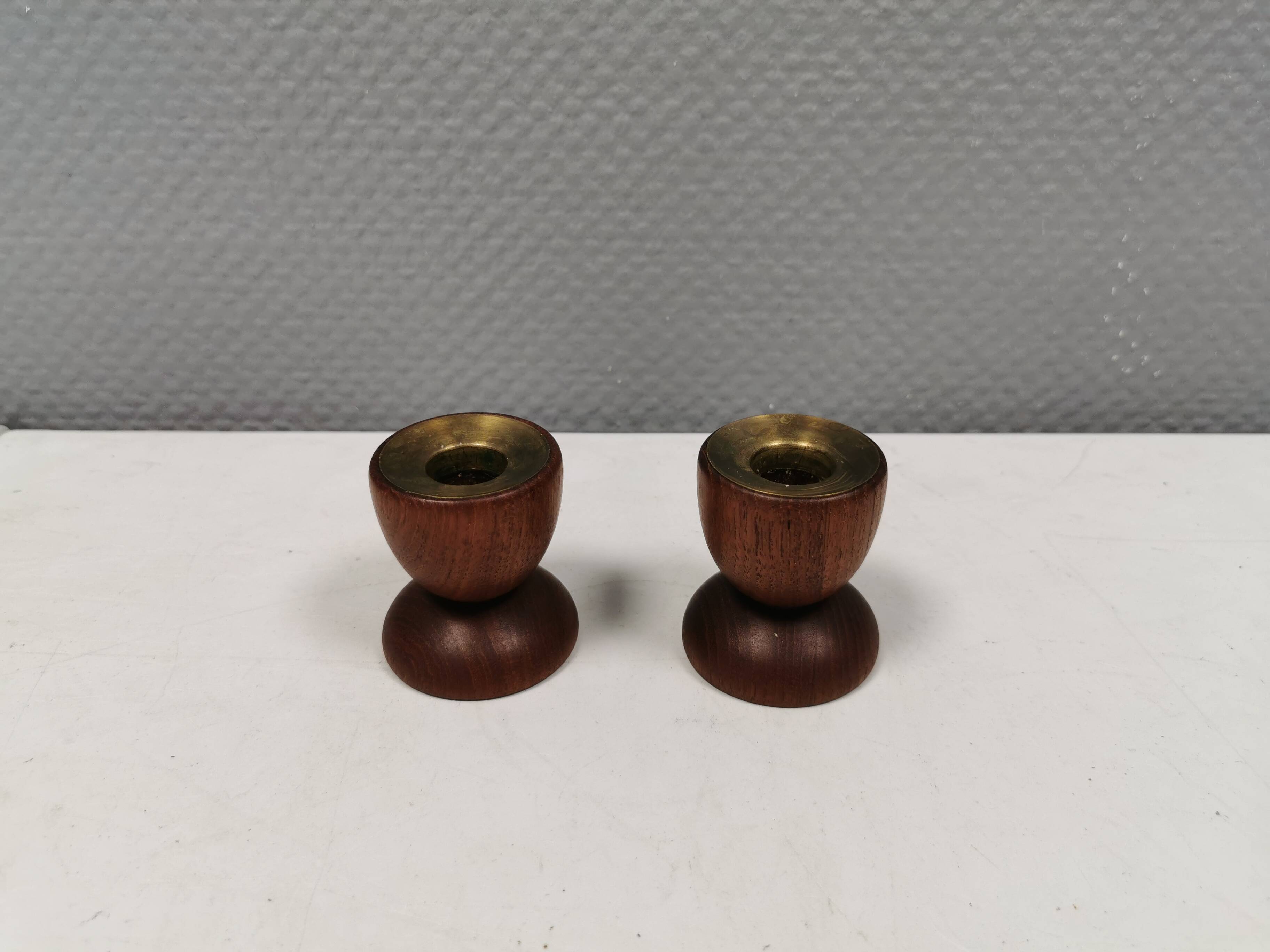 Two beautiful teak candle holders with brass inserts.